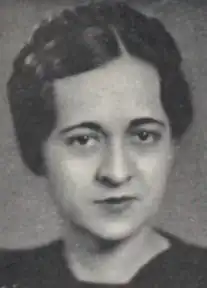 A young woman with dark eyes and dark hair braided across the crown