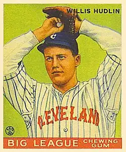 Baseball card image of a man in baseball uniform preparing to throw a pitch