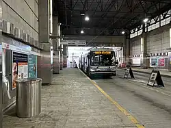 A silver-painted bus at an underground station