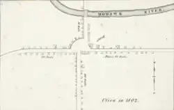 A black-and-white map, depicting buildings and roads in simple, small black outlines. The text "Utica in 1802" is at bottom right.